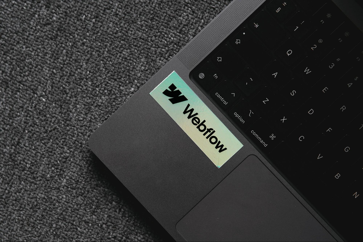 an image of a laptop that has a webflow sticker